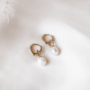 The Bronte Earrings feature a gold hoop with a removable pearl drop charm