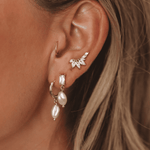 Harper Earrings feature a gold hoop stud with a drop pearl